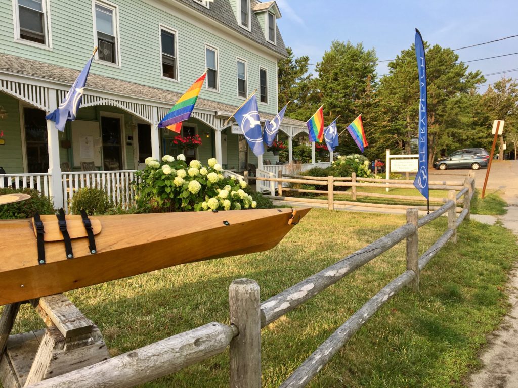 Porch and colorful flags at entrance to Ferry Beach Conference Center, Saco, Maine